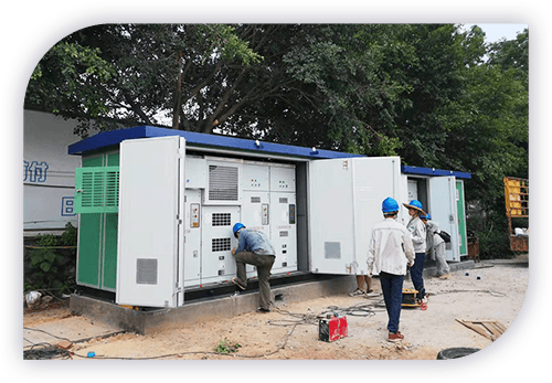  Engineers examining electrical machinery at an outdoor site